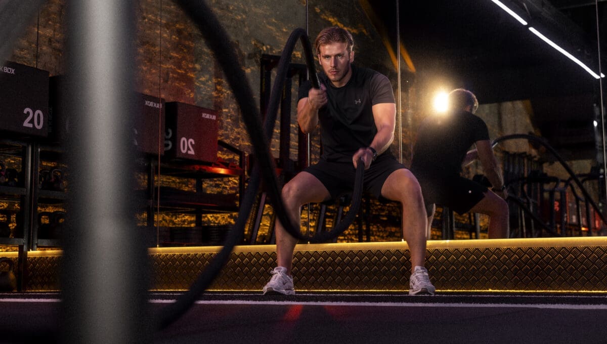 Person using battle ropes during HYROX workout in SAINT Studios